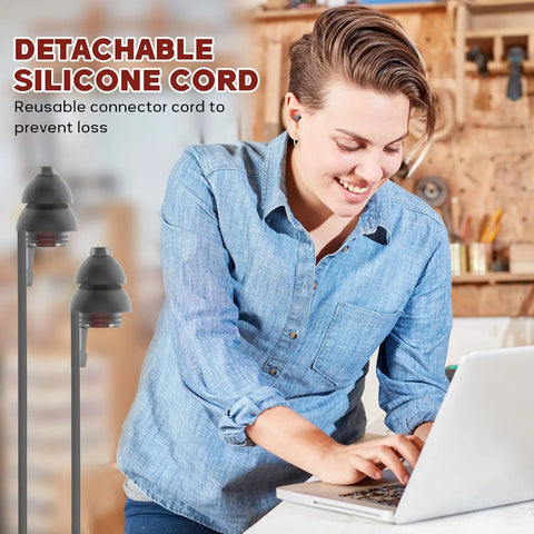 Person using laptop with High Fidelity Concert Earplugs For Musicians And DJs On Gigs shown with detachable silicone cord.