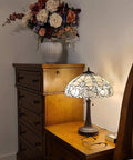 Tiffany Style Table Lamp With Floral Banker Design, Stained Glass White And Gray on a wooden nightstand, 23 inches tall