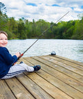 Child using Kids Telescopic Fishing Pole And Reel Combo With Tackle Box Easy Open Starter Kit by a lake on wooden dock
