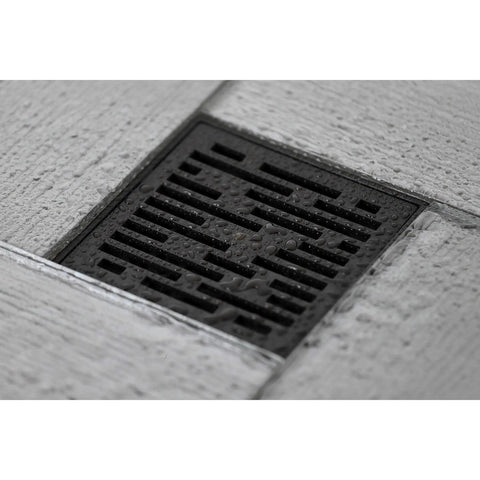 4 Inch Brass Square Grid Shower Drain With Hair Strainer, Oil Rubbed Bronze Finish installed in a gray tiled floor