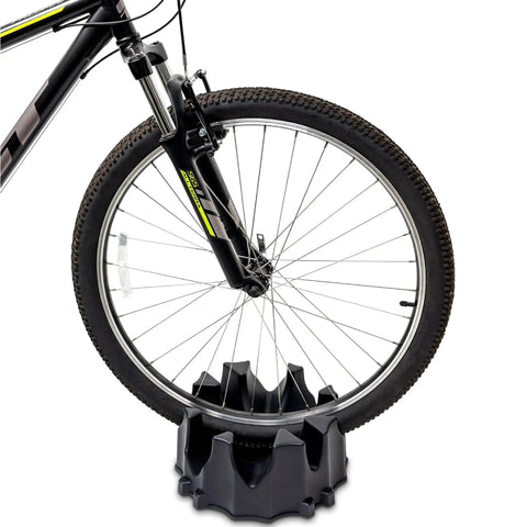 Mountain bike front wheel on a Front Wheel Riser Block For Bike Trainers With No Slip Design, 4 Tier Extender Stand.