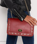 Framendino red leather crossbody bag with gold-tone turn-lock clasp, studded edges, and chain strap