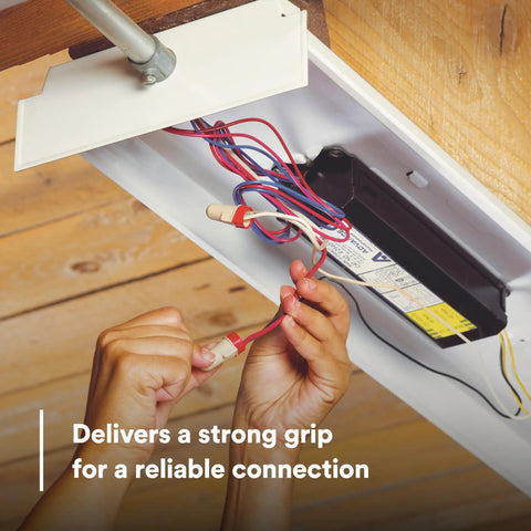 Hands connecting Solid As A Rock Tan And Red Wire Connectors For Twenty Two To Eight Gauge Cables to copper wires for secure pigtail hookups.