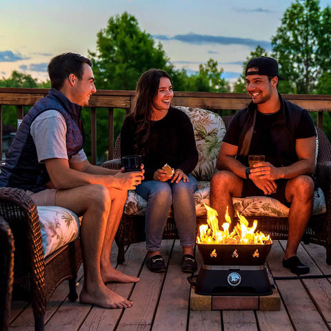 Group enjoying outdoor evening with Firecube 14 Inch Portable Smokeless Propane Fire Pit With Carry Kit And Lava Rocks, 58,000 BTU, Black.