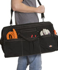 Man carrying black 20 Inch Durable Canvas Tool Tote For Painters Carpenters And Builders with shoulder strap filled with tools