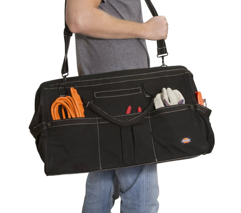 Man carrying black 20 Inch Durable Canvas Tool Tote For Painters Carpenters And Builders with shoulder strap filled with tools