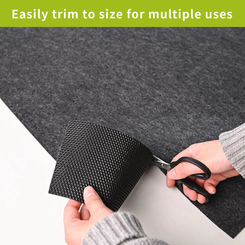 Person cutting oil spill mat for garage floor under car 96 by 48 inches absorbent with waterproof backing protects concrete epoxy and tile.