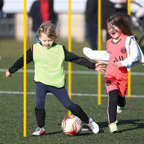 Kids play soccer with Six Piece 5 Foot Agility Poles For Soccer Basketball Football And More Pro Grade Speed And Footwork Training Sticks
