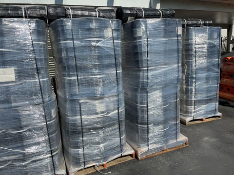 Pallets of Open Steel Strapping Seals Half Inch By One And A Quarter Inch Galvanized Metal Banding Clips wrapped in plastic