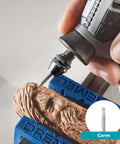 Close-up of a Dremel rotary tool carving wood secured in a blue vise clamp