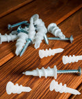 White Plastic Drywall Anchors Kit With 300 Pieces For Heavy Duty Drywall Repair And Installation on wooden surface