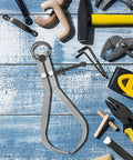 Built Tough Carbon Steel Caliper Kit For Hella Accurate Woodturning placed on a wooden workbench with tools around.