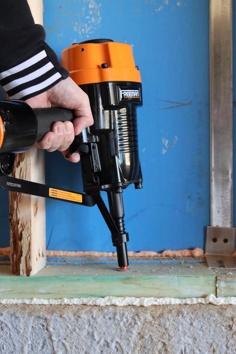 PSSCP 3 Inch Pneumatic Single Pin Concrete Nailer with case in use, fastening wood to concrete in a basement framing project.