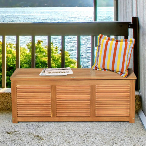 Acacia Wood Deck Box Bench 47 Gallon Outdoor Storage Chest With Seating on balcony with pillow and magazine on top