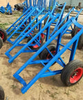 Tough As Nails Heavy Duty Pole Hauler Cart For Concrete Utility Lines And Long Material Transport With Swivel Casters And Bulletproof Steel Chassis Assembly in blue with red wheels.