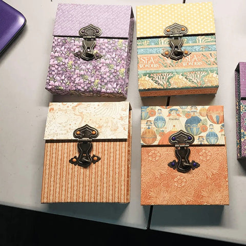Five Piece Set Of Retro Antique Bronze Heart Shaped Box Hasp Lock Latches Featuring Tough As Nails Zinc Alloy Construction And Smooth Brass Plating To Keep Your Jewelry Boxes Solid And Fade Free Always, displayed on colorful boxes.