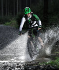 Cyclist splashes through water on night ride with Two Pack Aircraft Aluminum Waterproof 300 Lumen LED Bike Light Set With Headlight And Taillight
