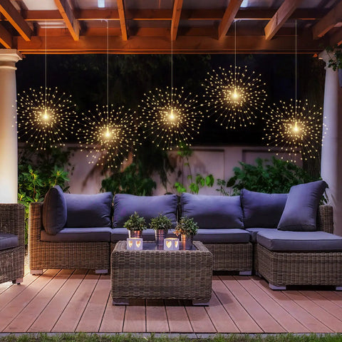 Dope 200 LED Hanging Sphere Lights with copper wire illuminating outdoor patio with sofa set, showcasing warm white glow.