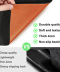 Close-up of oil spill mat with black top layer and orange waterproof backing, showcasing material texture and features vs competitors.