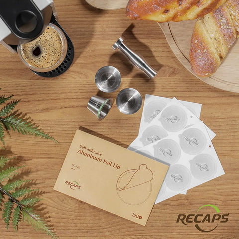 Reusable Coffee Filter Capsules Set For Nespresso Original Machines with accessories including tamper and foil lids on table.