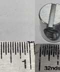 Close-up of 12 Pack Cross Dowels Barrel Nuts 12mm By 10mm Zinc Plated 10-24 Thread CNC Steel Hardware next to ruler