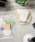 Crystal Clear 11x14 Self Sealing Sleeves Pack Of 100, 1.6 Mil Acid Free Resealable Bags with toiletries and comb on table