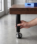 Adjustable Metal Desk Legs With Wheels Boss Level Mobility 4.7 To 7.1 Inches Height Adjustable Furniture Feet shown in use