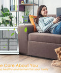 Woman relaxing on couch with air purifier, showcasing Replacement Filter Set For Holmes HAPF600 Series Air Purifiers With 3 HEPA Filters.