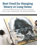Two people using Beefy Heavy Duty French Cleat Hanger 45 Inch System to mount large framed picture securely on wall