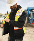 Mens High Visibility Reflective Safety Vest Premium Black Bottom Zipper Ansi Class 2 Construction Utility Workwear Lime Green Large worn outdoors.