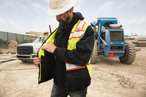 Mens High Visibility Reflective Safety Vest Premium Black Bottom Zipper Ansi Class 2 Construction Utility Workwear Lime Green Large worn outdoors.