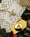 Trimscape Toilet Supply Kit in polished brass displayed on decorative tiles with floral background.