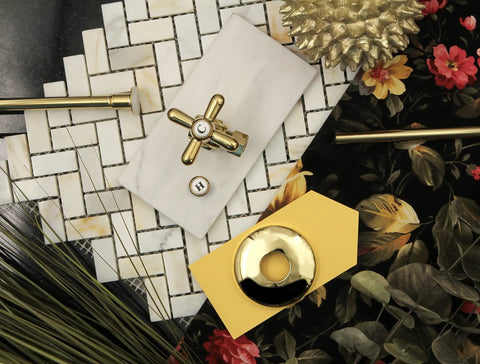 Trimscape Toilet Supply Kit in polished brass displayed on decorative tiles with floral background.
