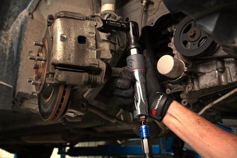 Mechanic using 1077XPA Half Inch Air Ratchet Wrench With 360 Degree Exhaust Adjustable Power Regulator 54 Foot Pound Torque 160 RPM Beefy Build For Automotive And Maintenance on vehicle brake system