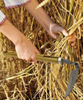 Person using Durable Hand Weeder Sickle Tool with Hardwood Handle for easy weeding and mowing in harvest field.