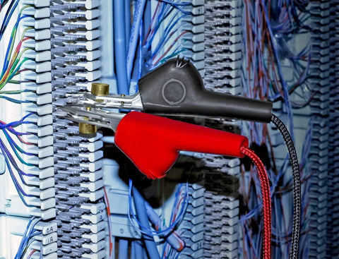 Close-up of Contractor Telephone Test Kit With Hi-Z Monitoring That Wont Disrupt Net Angled Bed-Of-Nails Clips in use on wiring panel