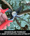 Heavy-Duty Go-To Pro Cut Bypass Hand Pruner slicing through a thick branch, red handle, forged steel blade, 1 inch cutting capacity