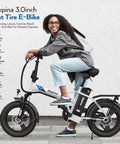 Peak 500W Step Through Fat Tire Electric Bike With 48V Removable Battery For Easy Recharges And Long Rides Up To 40 Miles 7 Speed LCD Display Sixteen Inch By Three Inch Fat Tire For City Cruisin And Trail Ridin, side view with rider