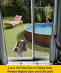 Dog looking through glass sliding door fitted with Glass Sliding Door Lock Black Foot Lock For Patio And Sliding Doors Extra Security For Home And Travel Child Safety Lock For Sliding Doors Sliding Door Stopper And Secure Access Device To Prevent Unwanted Openings Peace Of Mind in backyard.