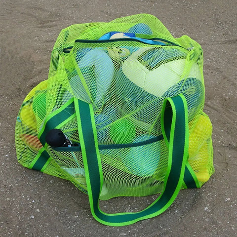 Green Must-Have Mesh Beach Toy Bag With Zipper Top For Easy Carry And Quick Dry Sand-Drain Net Tote filled with beach toys.