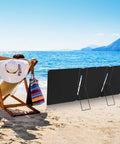 Beach scene with 2 Pack Portable Folding Solar Panel Stand With Quick Angle Adjustment Lightweight Mount for camping or emergencies.
