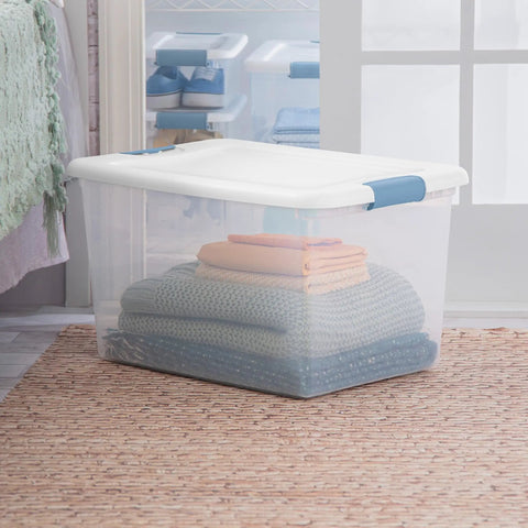 64 Quart Clear Latching Storage Box with White Lid, shown storing folded blankets, ideal for home and dorm organization.