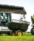 Heavy Duty Lawn And Garden Trailer With 900 Lb Capacity 15 Cu Ft Poly Tub Tilt And Pivot Frame in use on grassy field