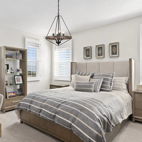 Farmhouse Rustic Black Chandelier With 4 Lights for Bedroom, octagonal design, hanging above modern bed in bright room.