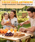 Nisuez Heavy Duty Manual Fruit Juicer Press For Lemons Limes Oranges in use during a family picnic outdoors, extracting juice.