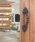 Vintage Cast Iron Door Handle Set 2 Pack Built Tough For Farmhouse Style Cabinet Pulls And Sliding Doors Fence Gates Cupboards Durable Antique Brown Finish installed on a wooden door in a rustic interior.