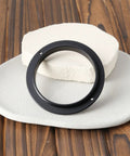 Male To Male M54x0.75 Telescope Adapter Ring For 50Mm Lens Filter shown on wooden surface with 54x0.75 threads visible