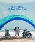 Wind Assist Kit For Shade 2.0 And Earlier By Shibumi Stabilizes Beach Canopy, features people relaxing under a beach shade.