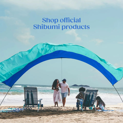 Wind Assist Kit For Shade 2.0 And Earlier By Shibumi Stabilizes Beach Canopy, features people relaxing under a beach shade.