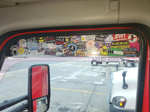 Truck window covered with Blue Collar Humor 100 Pack Waterproof Hard Hat Stickers For Tool Boxes Welding Helmets and Mechanics.